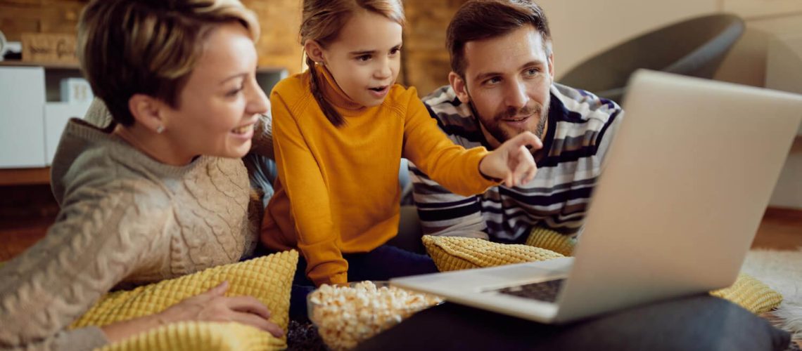 small-girl-her-parents-watching-something-computer-home (1)